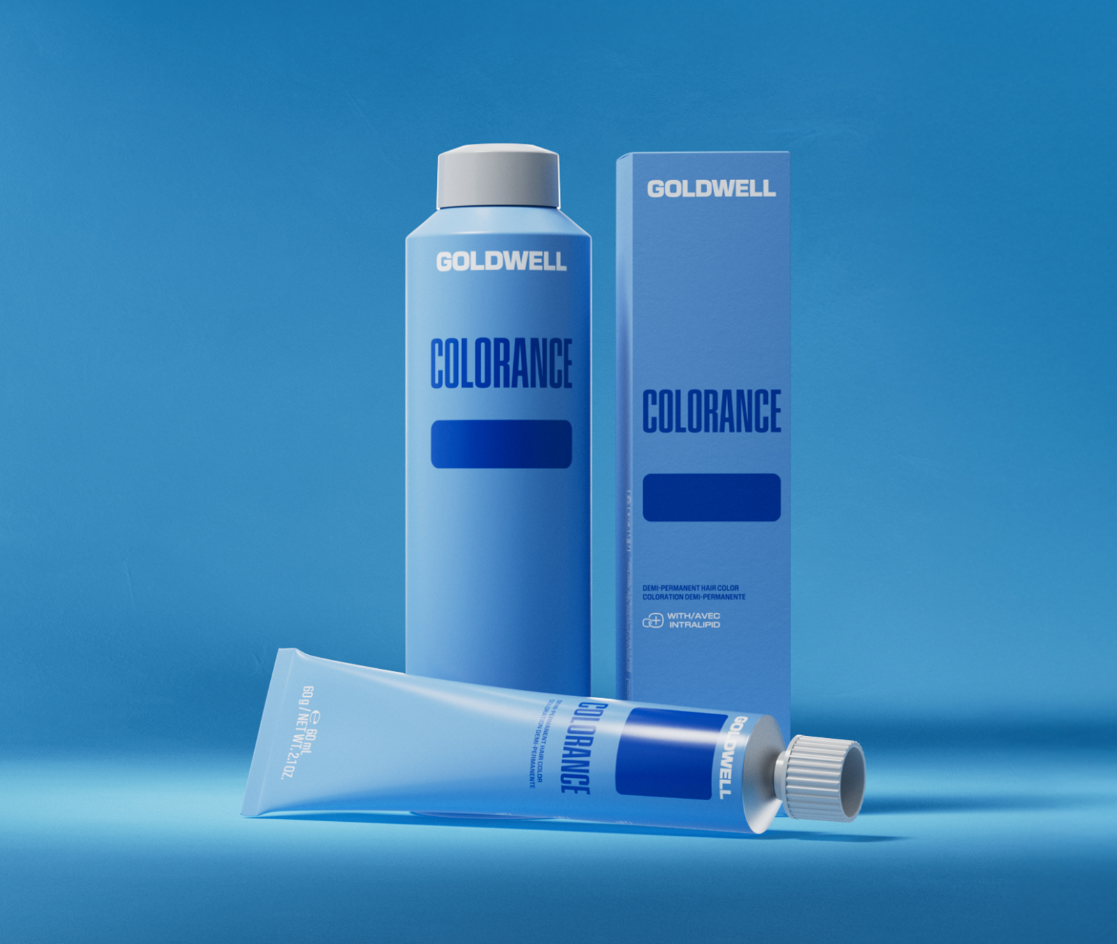 Goldwell Colorance product photo: a blue demi-permanent bottle, its carton, and a tube against blue