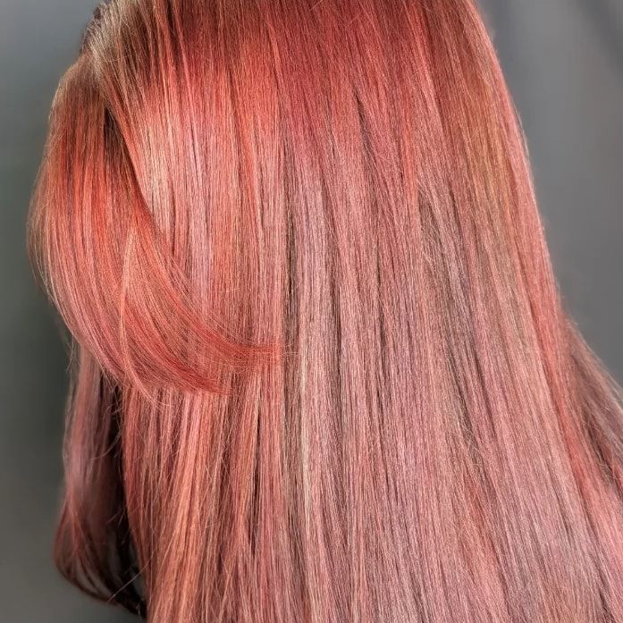 Side view of glossy rose copper hair, corrected from a faded teal