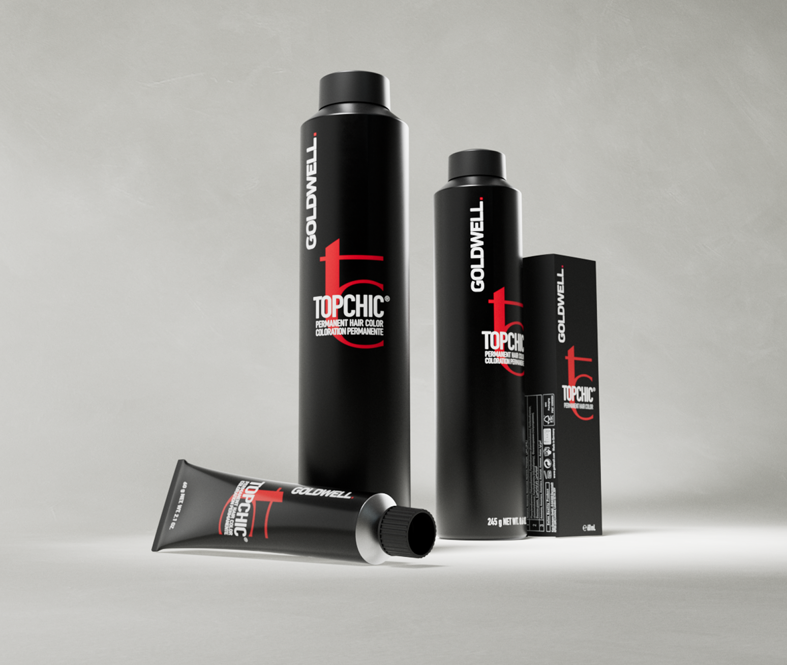 Goldwell Topchic product photo: black permanent color cans standing beside a single tube