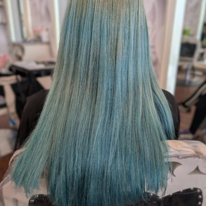 Before: long teal hair seen from behind, faded unevenly to a washed-out blue-green